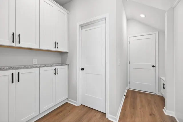 a view of a kitchen with sink and wooden floor