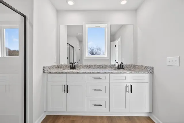 a bathroom with a granite countertop sink a toilet and bathtub