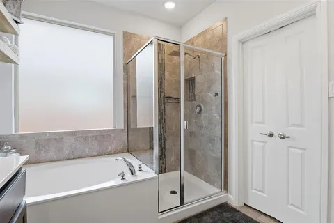 a bathroom with a bathtub and a shower