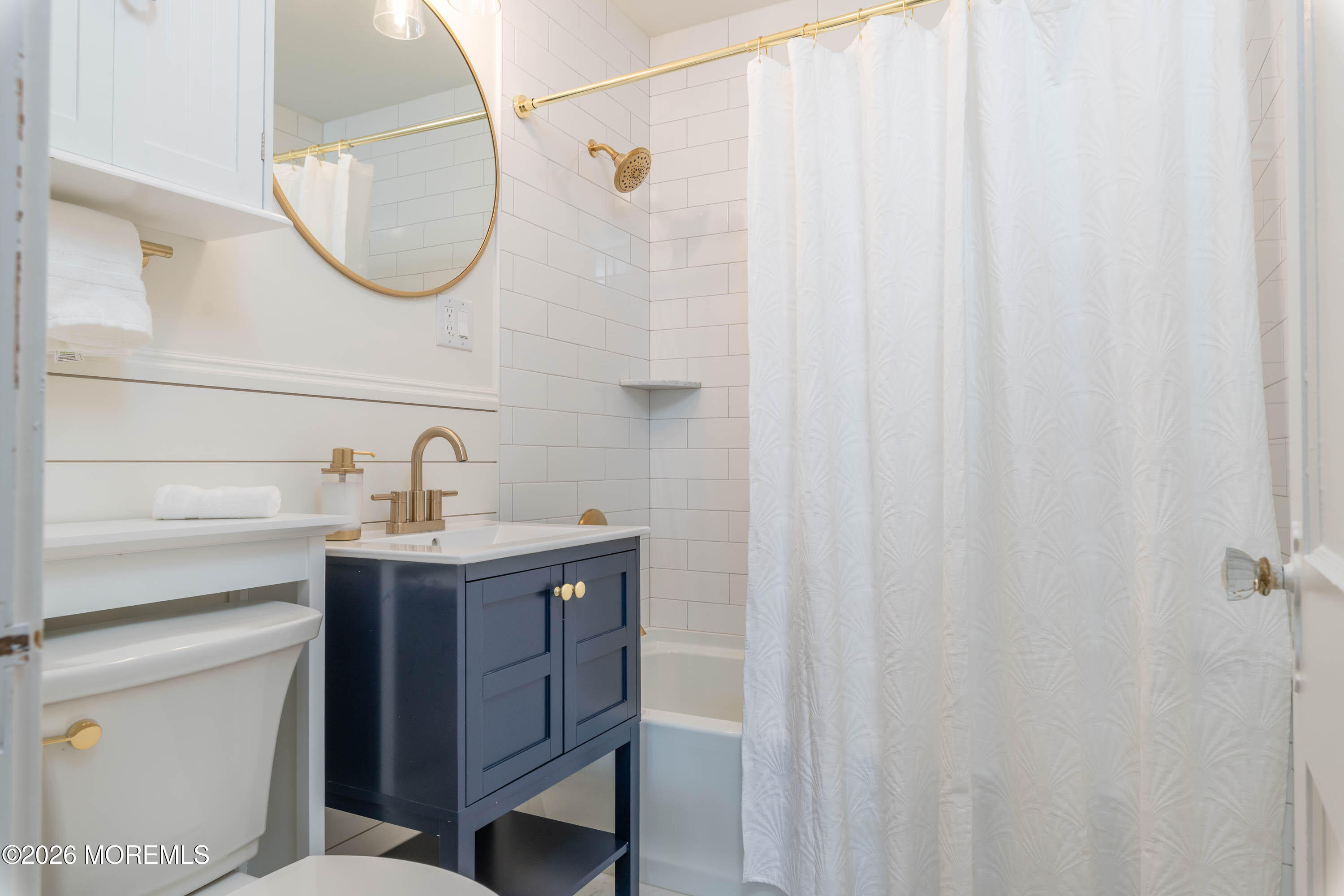 2 Via Ripa, Unit 1 Sea Bright, NJ 07760 - Photo 18 of 38 a bathroom with a sink a mirror and a shower curtain