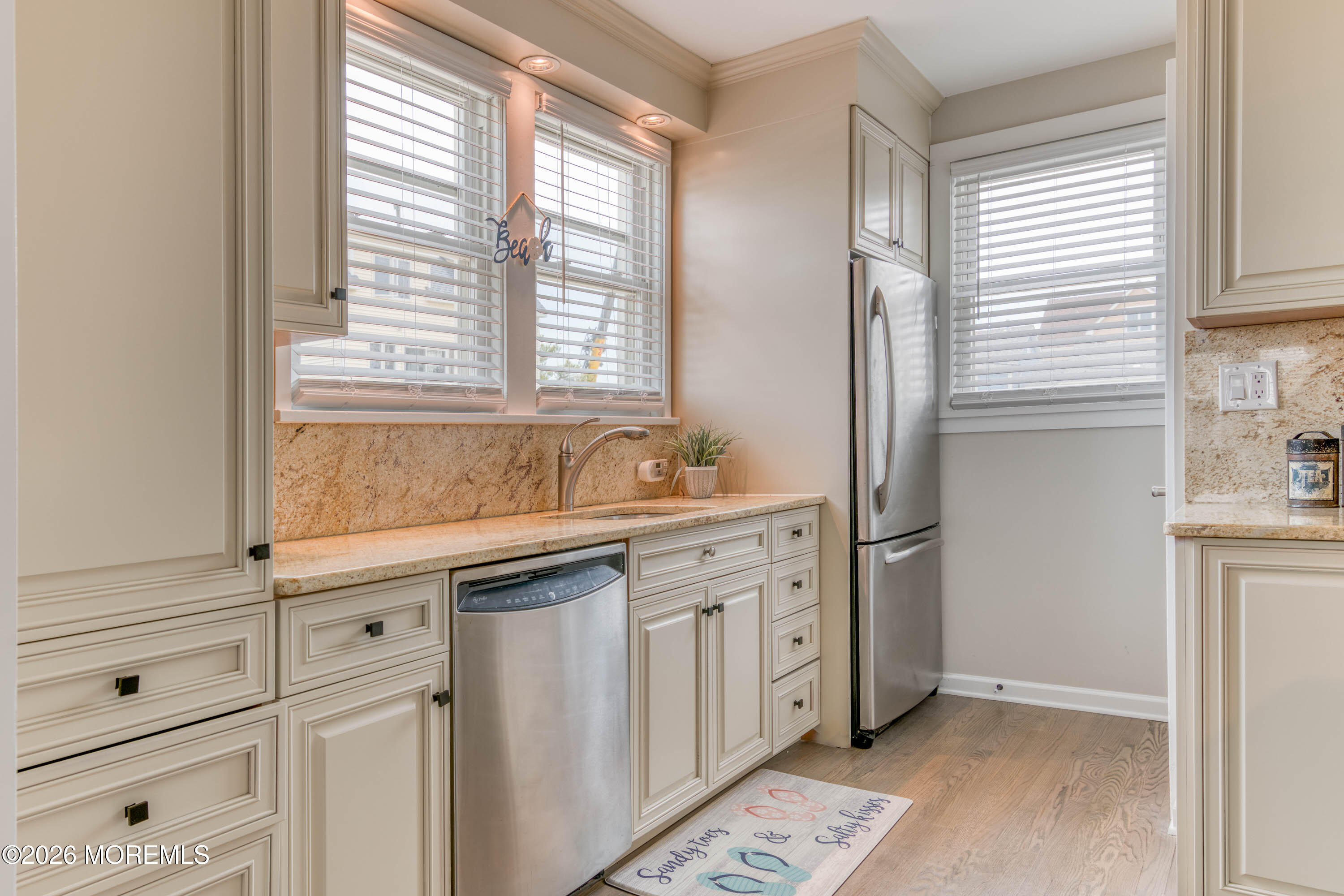 2 Via Ripa, Unit 1 Sea Bright, NJ 07760 - Photo 20 of 38 a kitchen with white cabinets and a sink
