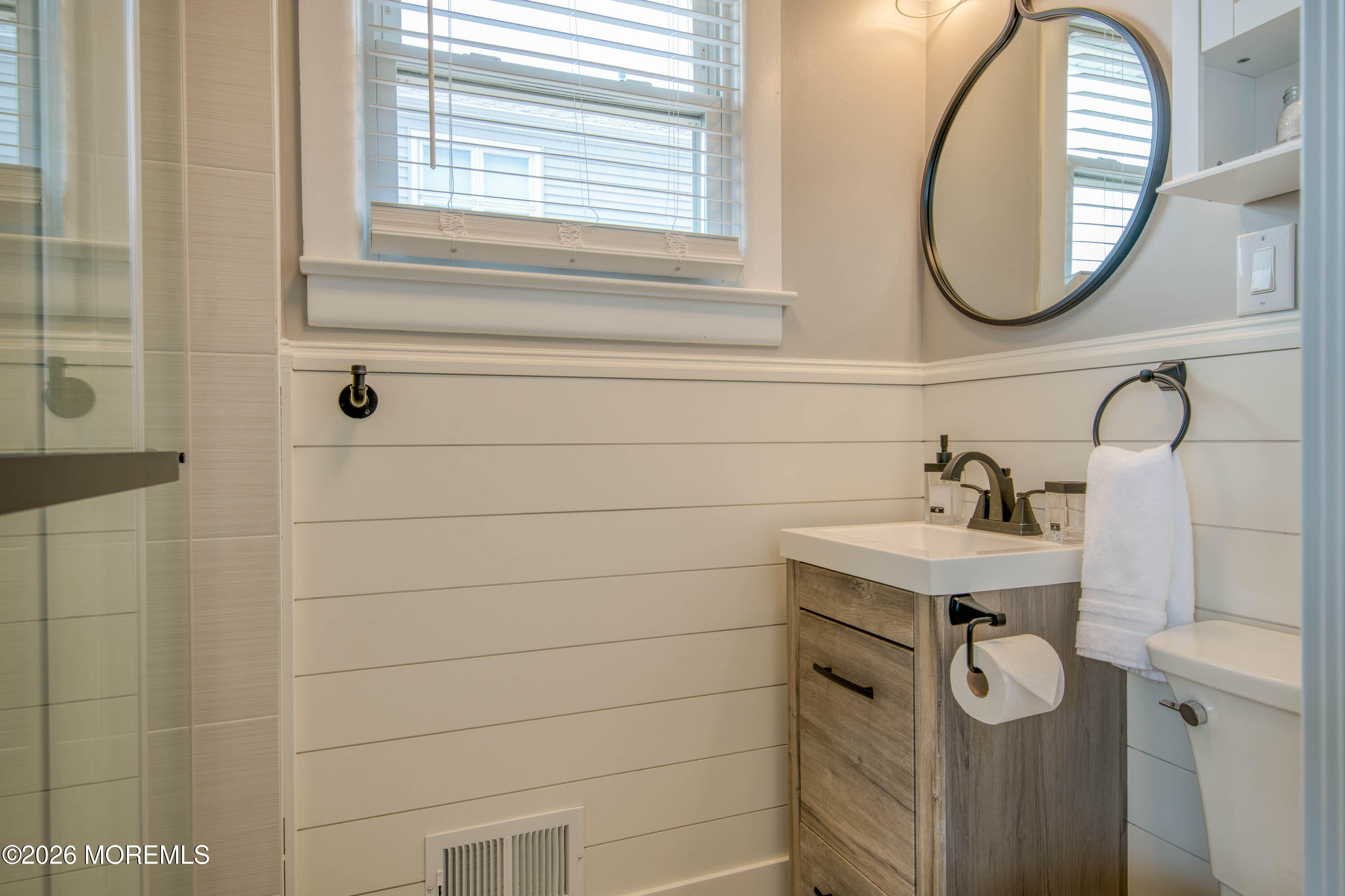 2 Via Ripa, Unit 1 Sea Bright, NJ 07760 - Photo 22 of 38 a bathroom with a granite countertop sink a mirror and a shower
