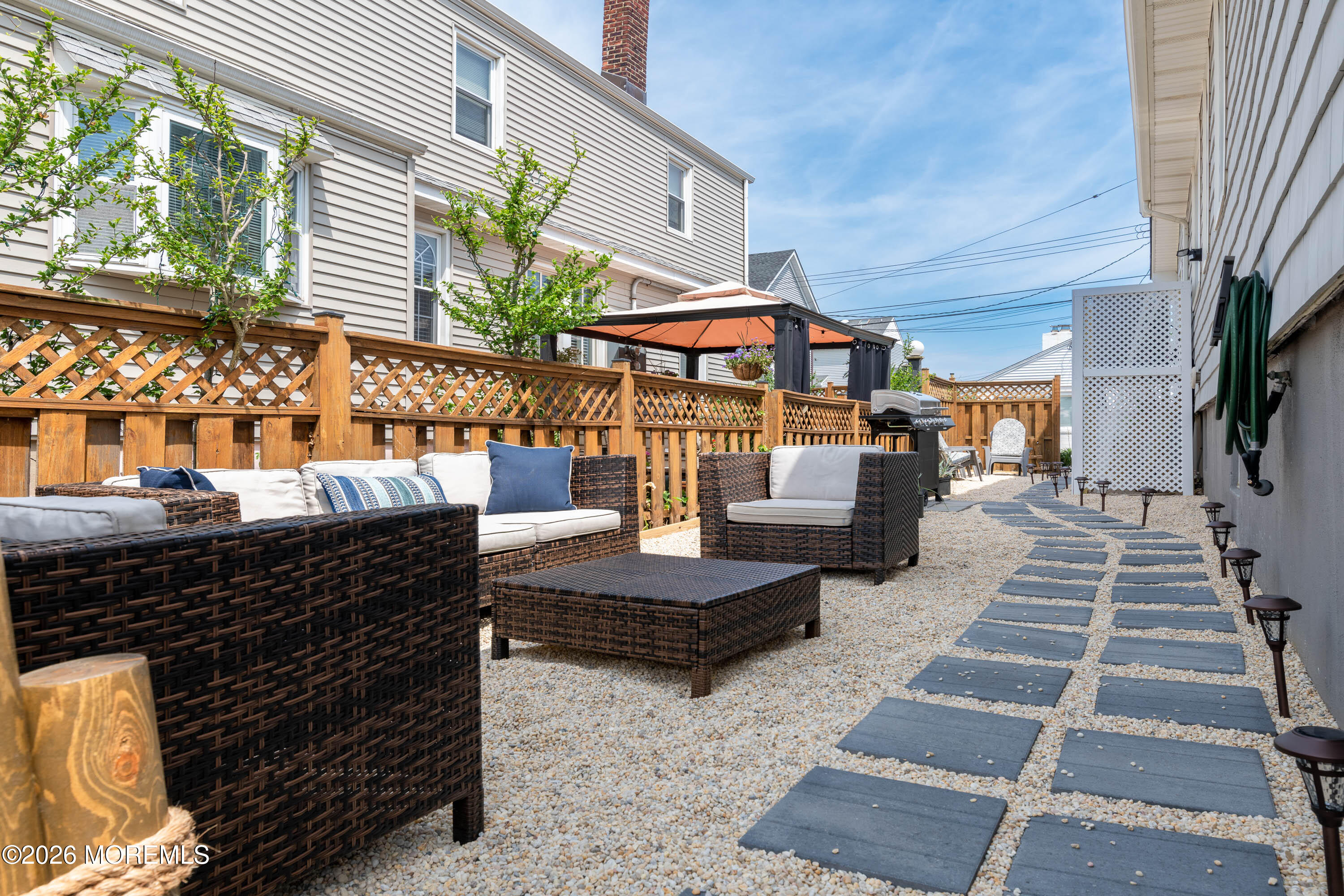 2 Via Ripa, Unit 1 Sea Bright, NJ 07760 - Photo 25 of 38 a view of a patio with table and chairs potted plants with wooden floor