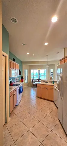 a kitchen with stainless steel appliances a refrigerator and a stove top oven