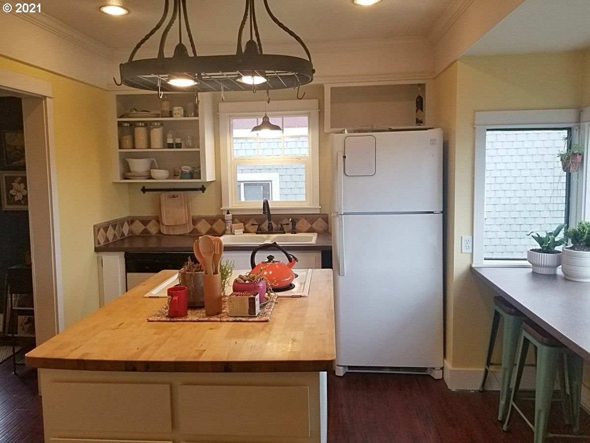 315 North 1st Avenue Ridgefield, WA 98642 - Photo 7 of 17 a kitchen with a refrigerator sink and wooden floor