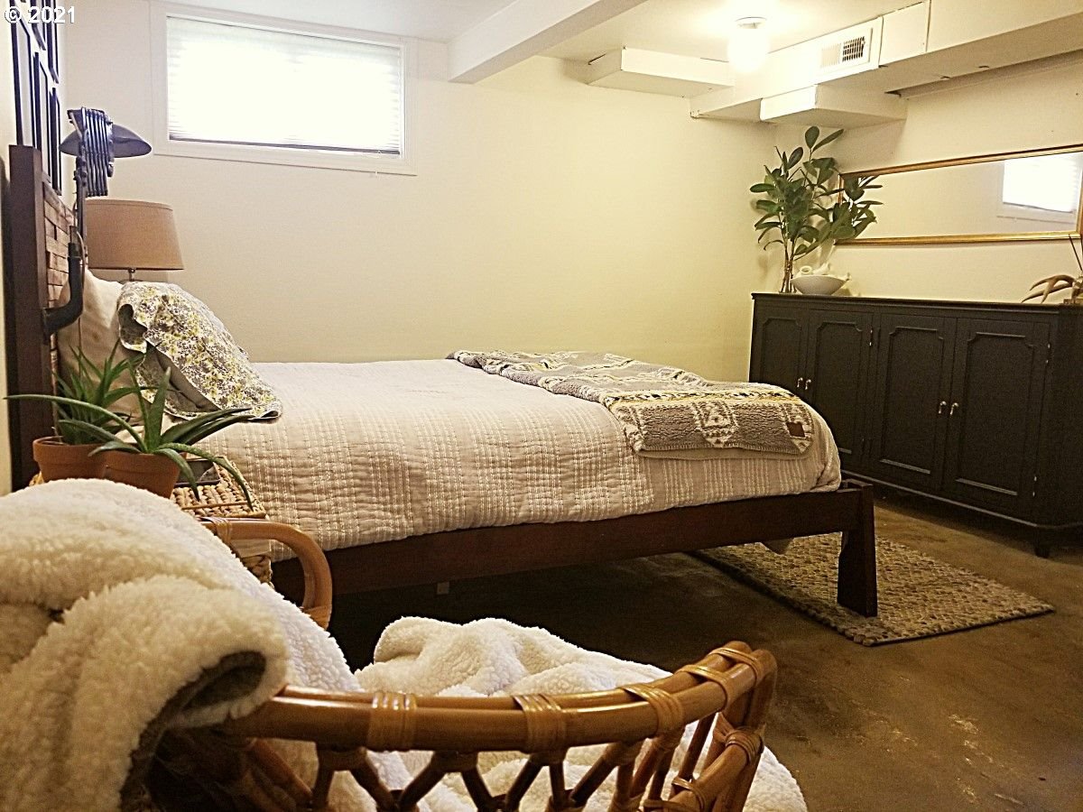 315 North 1st Avenue Ridgefield, WA 98642 - Photo 8 of 17 a bedroom with a bed and a chandelier