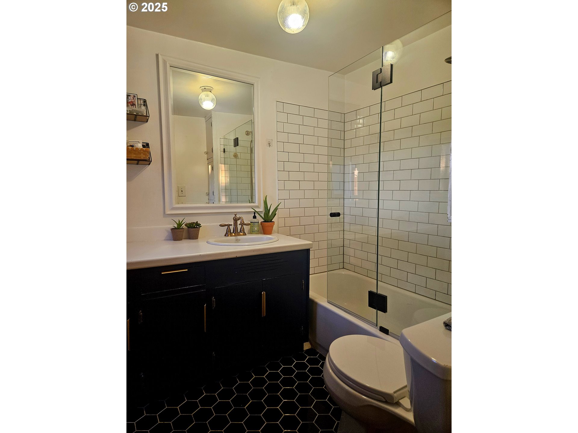 315 North 1st Avenue Ridgefield, WA 98642 - Photo 10 of 17 a bathroom with a sink toilet a mirror and shower