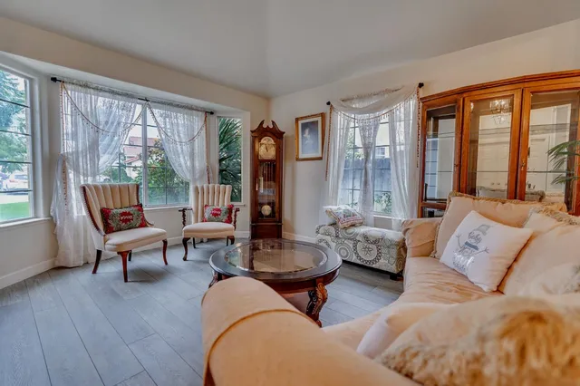 a view of a dining room with furniture and a large window