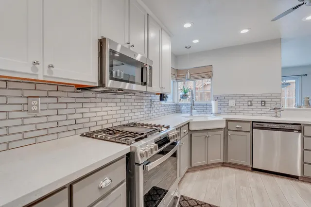 a dining room with furniture a chandelier and wooden floor