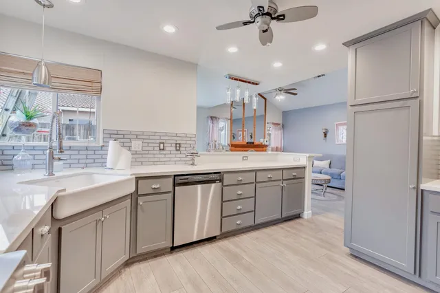 a living room with furniture a fireplace and a chandelier