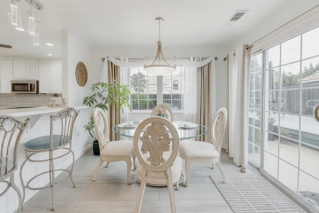 a living room with furniture and a floor to ceiling window