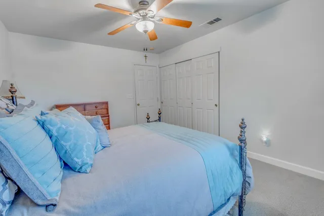 a roof deck with table and chairs and potted plants