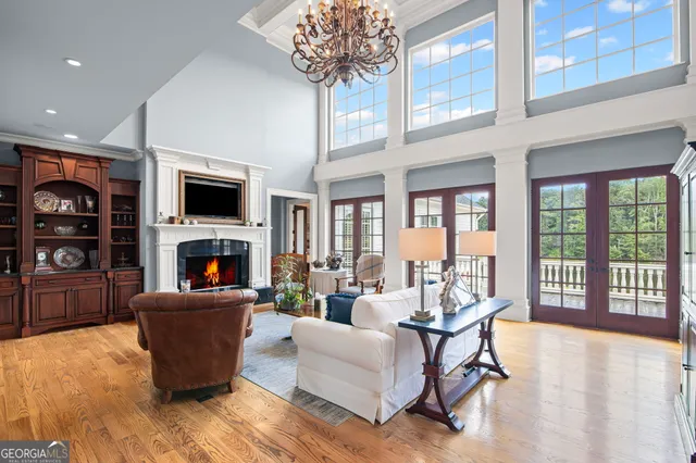 a bedroom with a bed couch and a large window