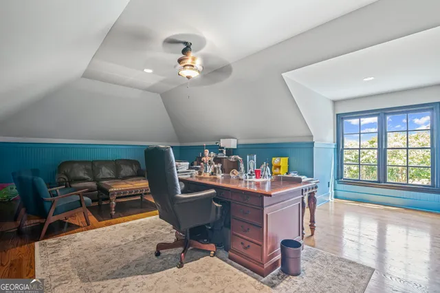 a living room with furniture and floor to ceiling window