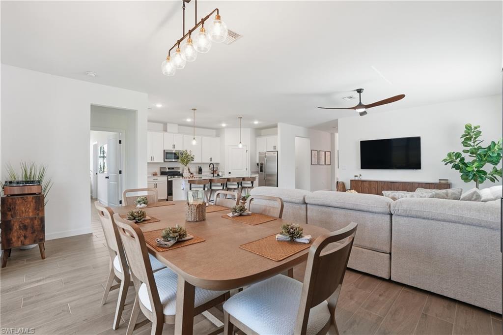 20428 Verawood Loop Estero, FL 33928 - Photo 14 of 50 Dining space with wood tiled floors, ceiling fan, and recessed lighting