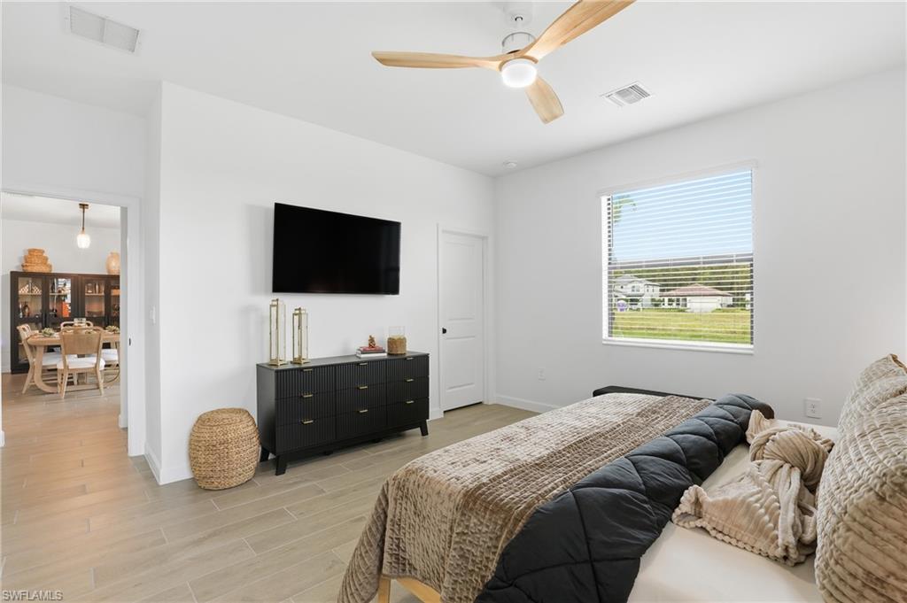20428 Verawood Loop Estero, FL 33928 - Photo 18 of 50 Bedroom featuring wood finish floors and ceiling fan