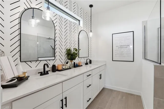 a bathroom with a double vanity sink and a mirror