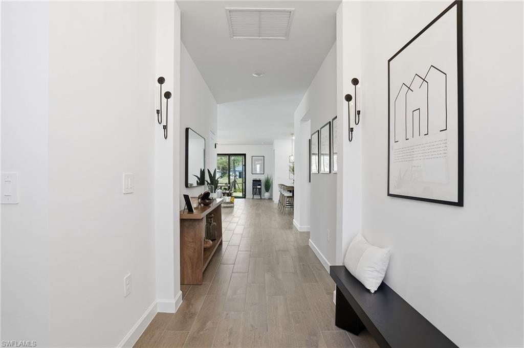 20428 Verawood Loop Estero, FL 33928 - Photo 2 of 50 Corridor with light wood-style floors and baseboards