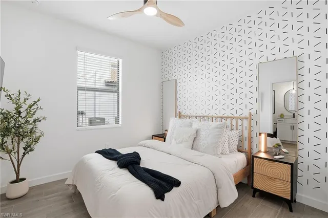 a bedroom with a bed and a potted plant