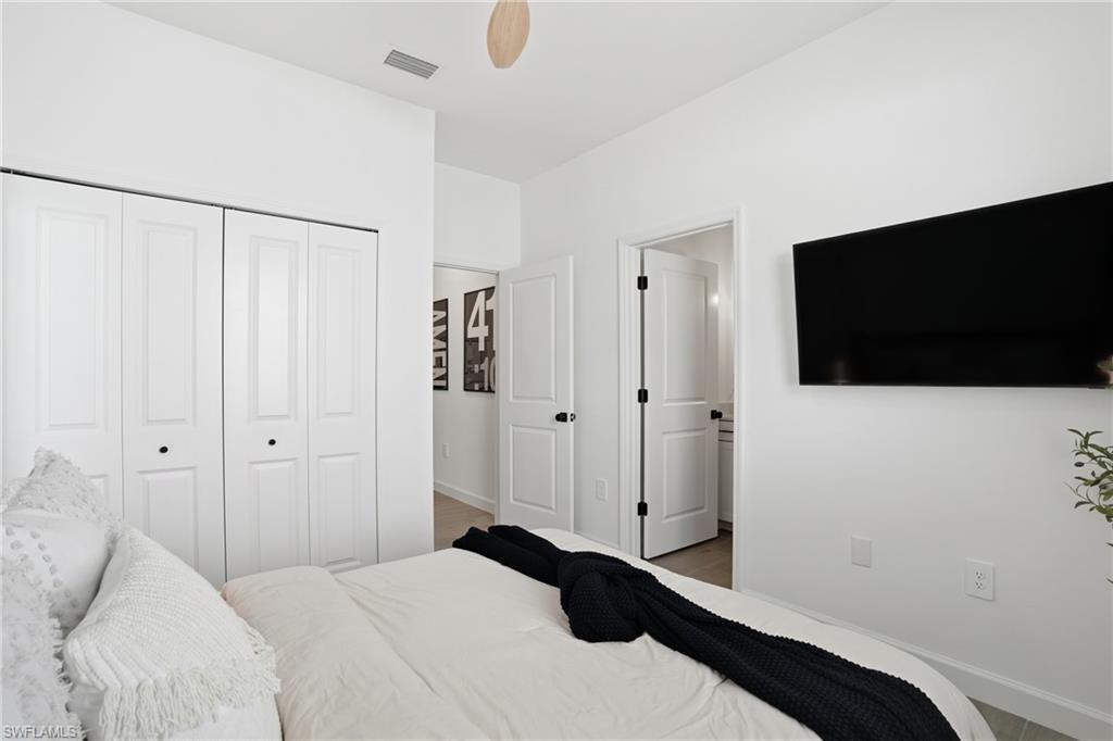 20428 Verawood Loop Estero, FL 33928 - Photo 22 of 50 Bedroom with a closet, a ceiling fan, and wood finished floors