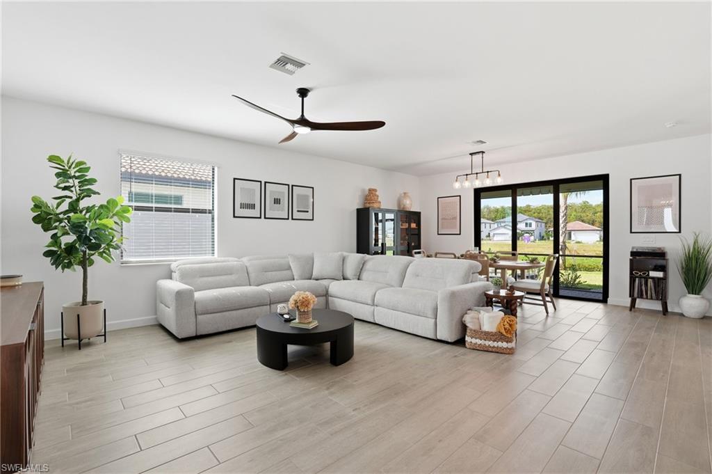 20428 Verawood Loop Estero, FL 33928 - Photo 3 of 50 Living area featuring a ceiling fan, light wood finished floors, and healthy amount of natural light