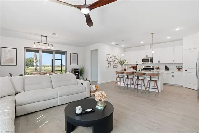 a living room with furniture and kitchen view
