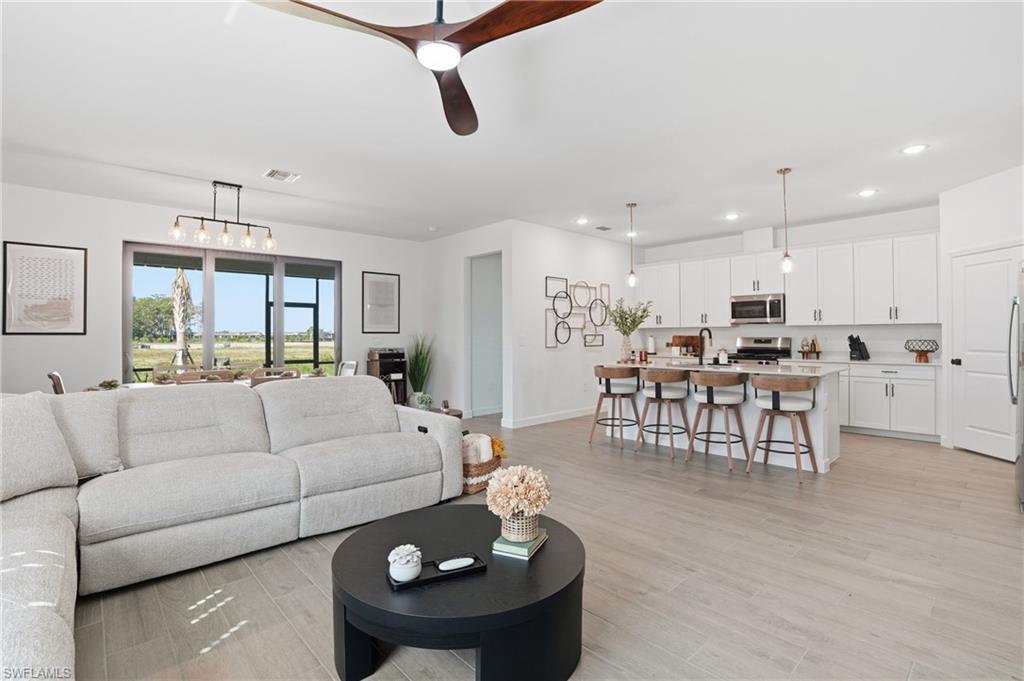20428 Verawood Loop Estero, FL 33928 - Photo 4 of 50 Living room with recessed lighting, a ceiling fan, and light wood-style flooring
