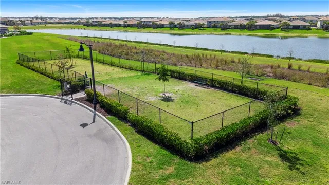an aerial view of a houses with outdoor space lake and green space