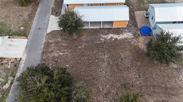 a view of a house with a yard and tree