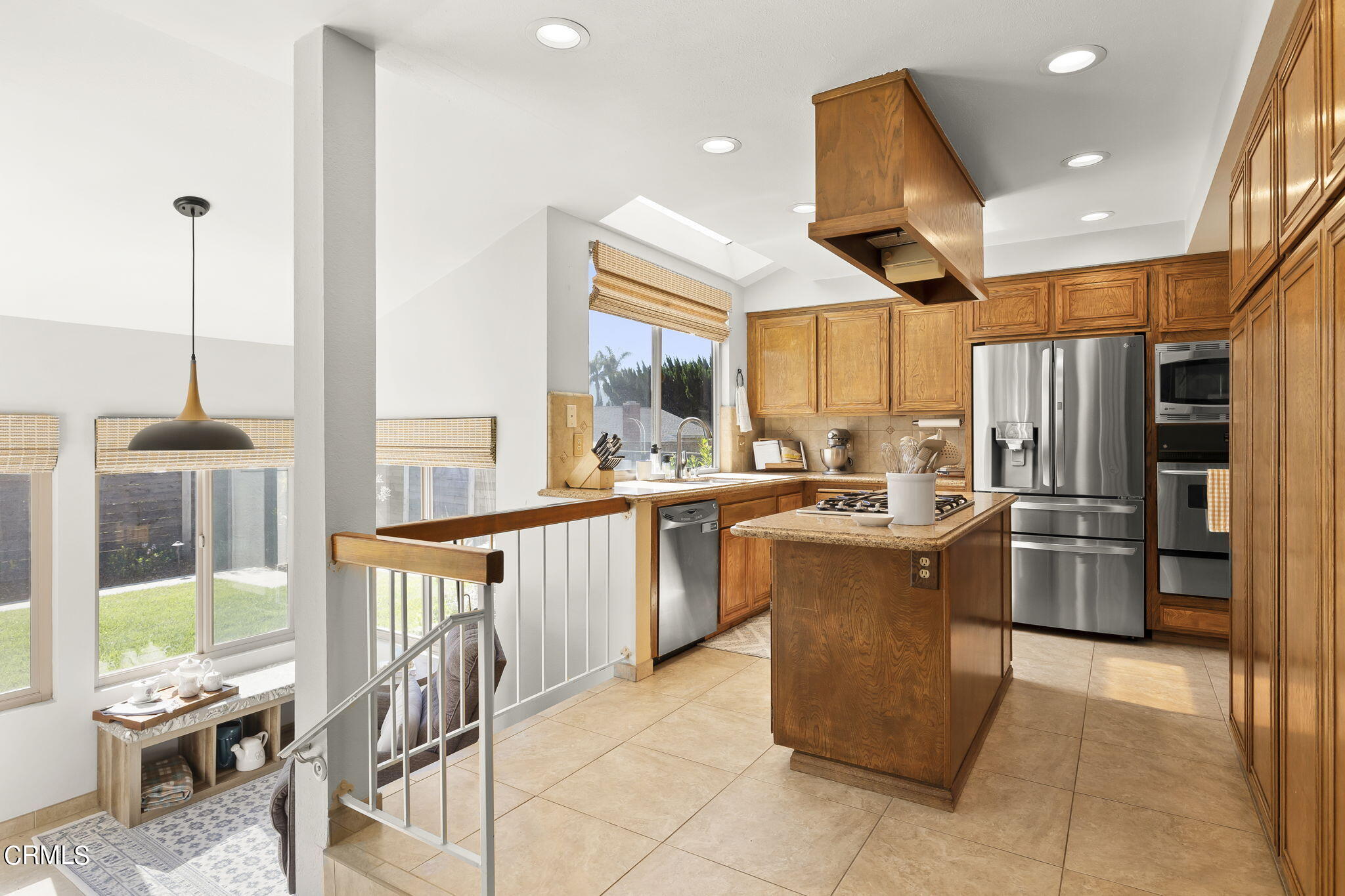 320 Fallen Leaf Avenue Camarillo, CA 93012 - Photo 12 of 49 a kitchen with stainless steel appliances kitchen island granite countertop a refrigerator oven a sink a dining table and chairs with wooden floor