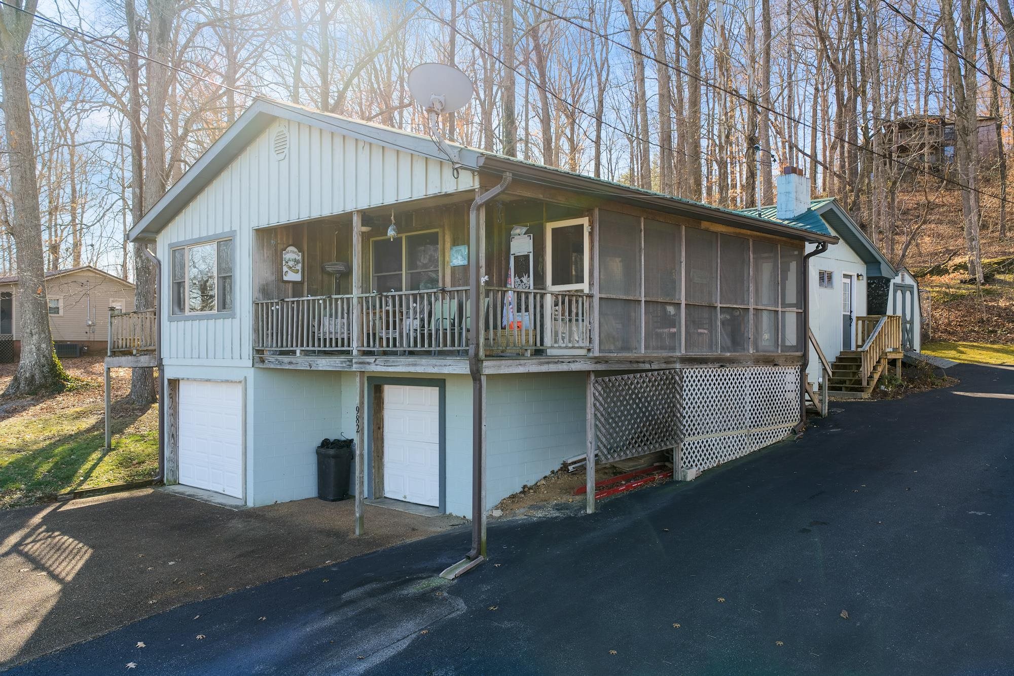 982 Lost Creek Boat Dock Road Decaturville, TN 38329 - Photo 2 of 31 a house with white door and outdoor space