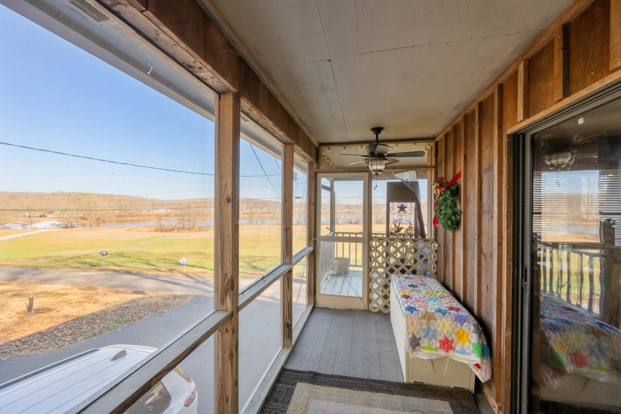 982 Lost Creek Boat Dock Road Decaturville, TN 38329 - Photo 7 of 31 a view of a balcony with wooden floor