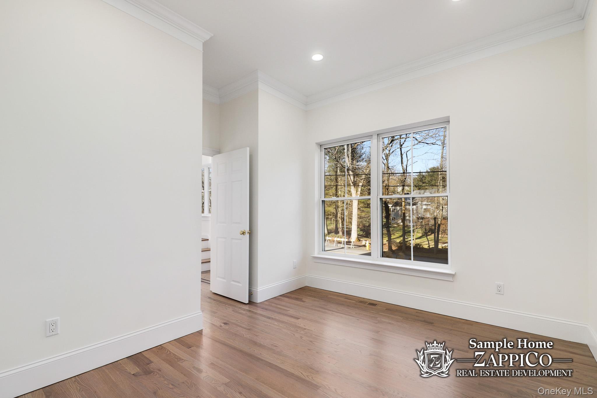 29 Gracemere Tarrytown, NY 10591 - Photo 11 of 16 an empty room with wooden floor and windows