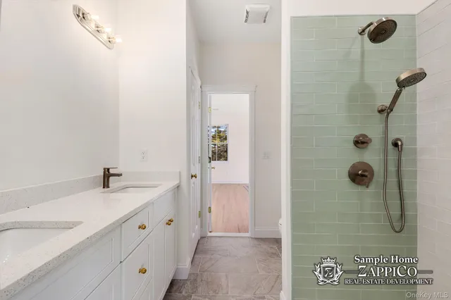 a bathroom with a granite countertop sink a mirror and a shower