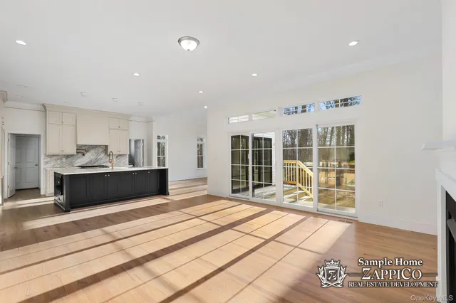 a view of a kitchen with granite countertop a sink and cabinets