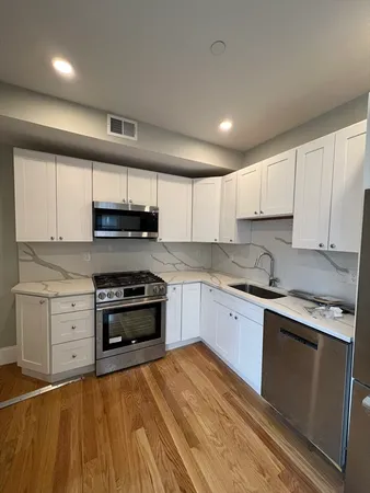 a kitchen with stainless steel appliances granite countertop a stove and a sink