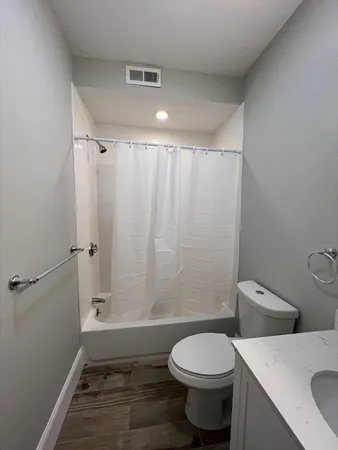 a bathroom with a toilet a sink and shower