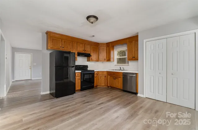 a kitchen with stainless steel appliances a refrigerator and a stove