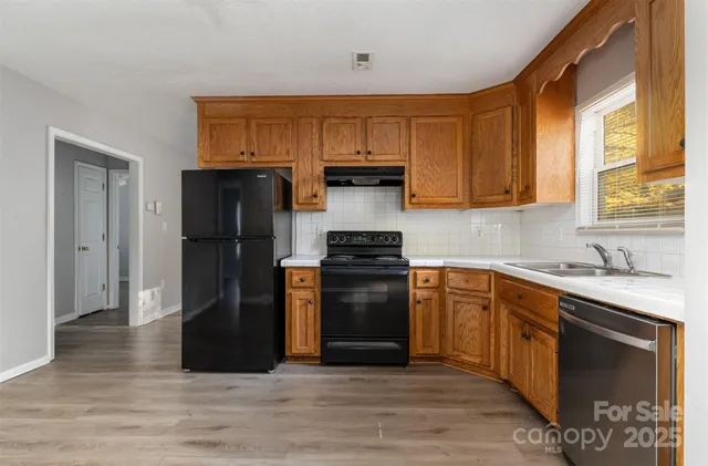 a kitchen with stainless steel appliances granite countertop a refrigerator stove and sink