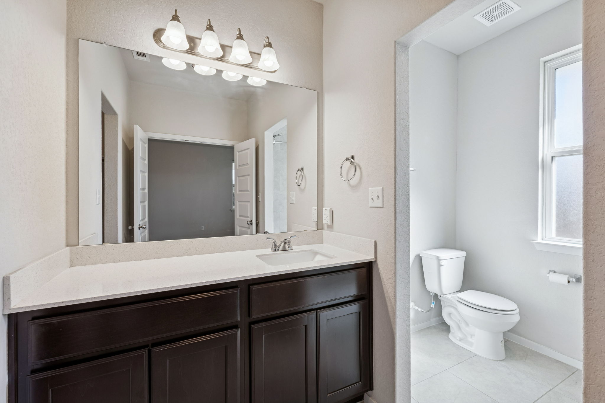 316 Insider Loop Elgin, TX 78621 - Photo 14 of 39 Bathroom featuring vanity, healthy amount of natural light, and light tile patterned floors