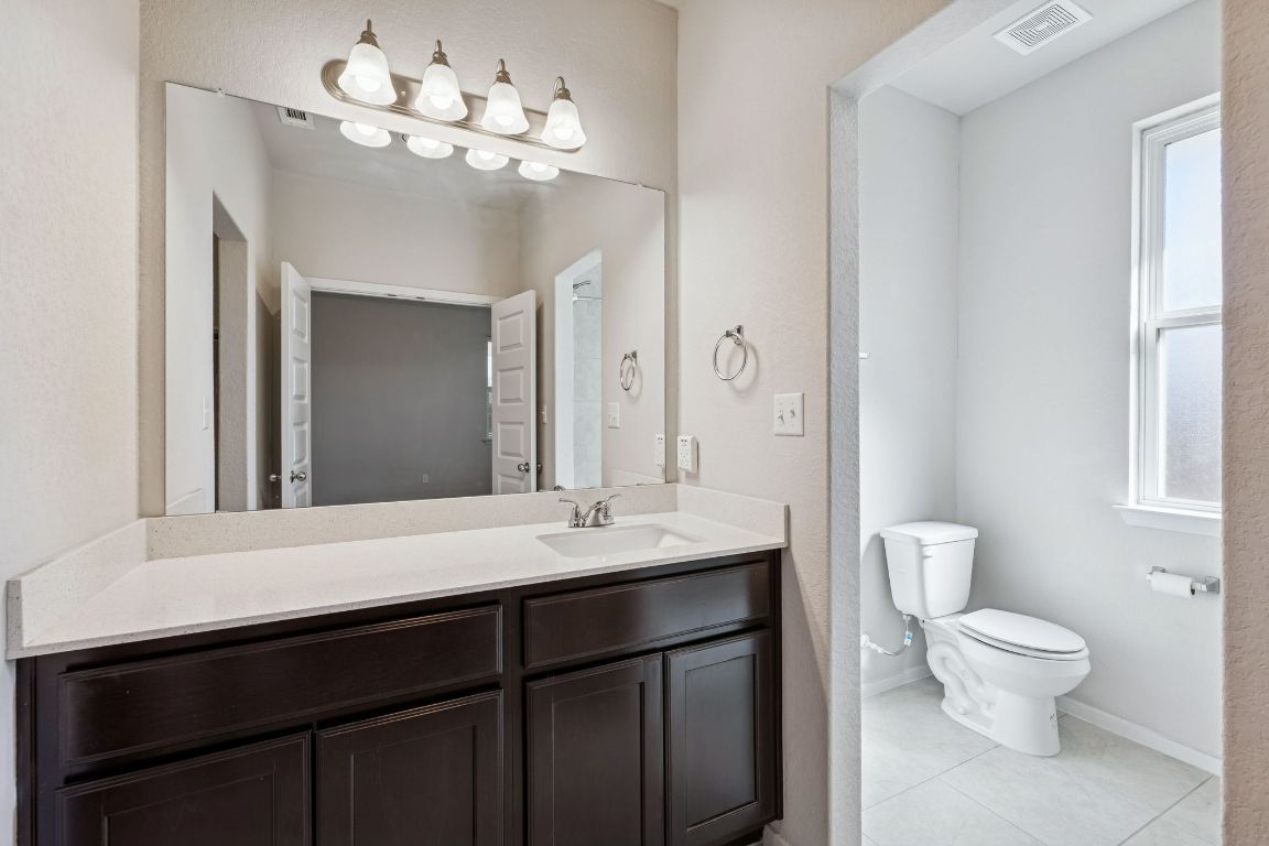 316 Insider Loop Elgin, TX 78621 - Photo 14 of 39 Bathroom featuring vanity, healthy amount of natural light, and light tile patterned floors