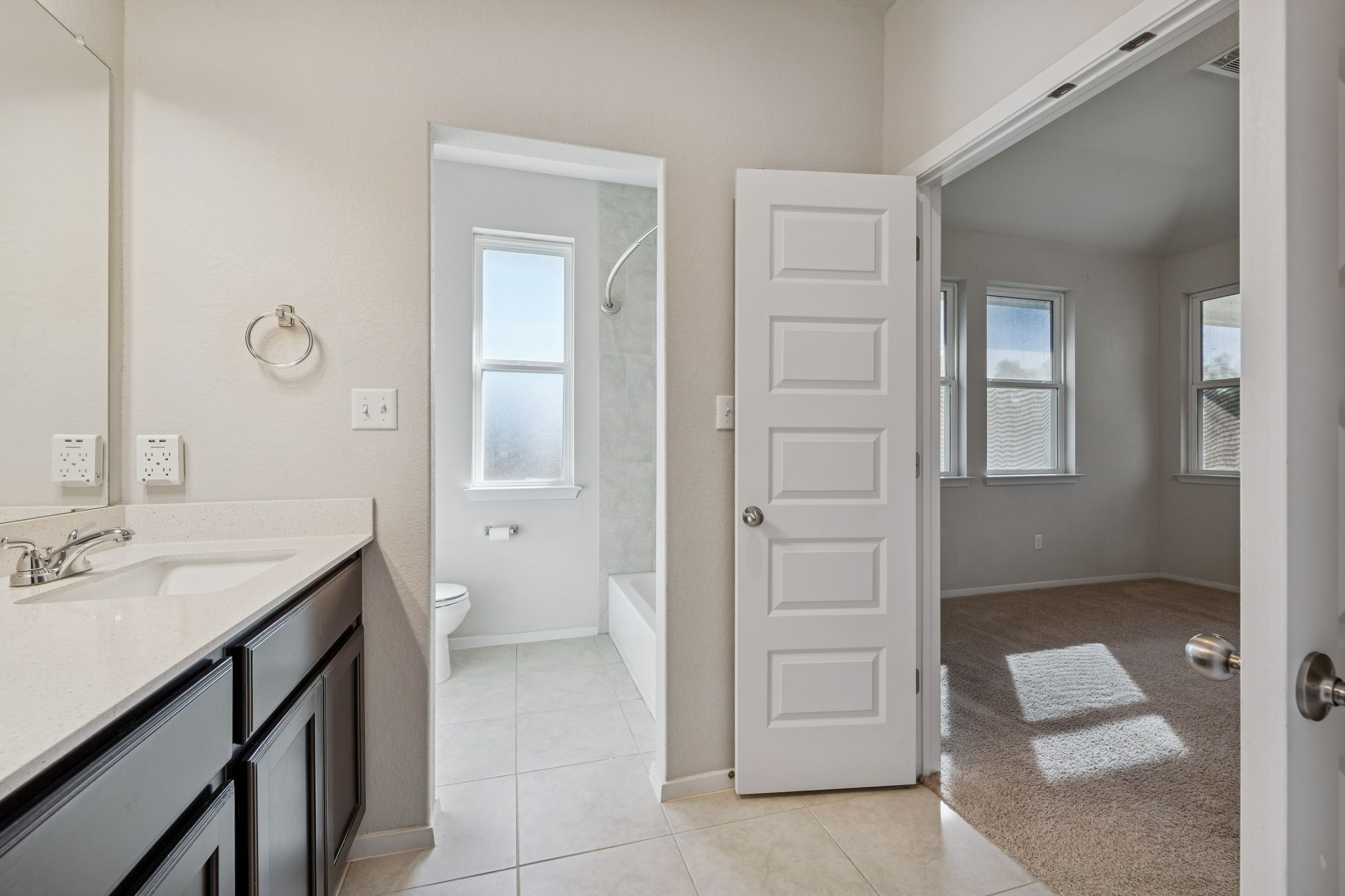 316 Insider Loop Elgin, TX 78621 - Photo 16 of 39 Bathroom with vanity, light tile patterned flooring, tub / shower combination, and light carpet