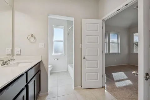 a bathroom with a toilet a sink and a mirror
