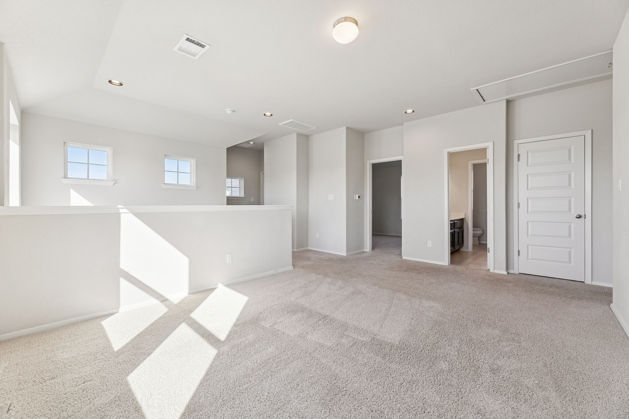 316 Insider Loop Elgin, TX 78621 - Photo 18 of 39 Unfurnished room with light carpet, attic access, and recessed lighting