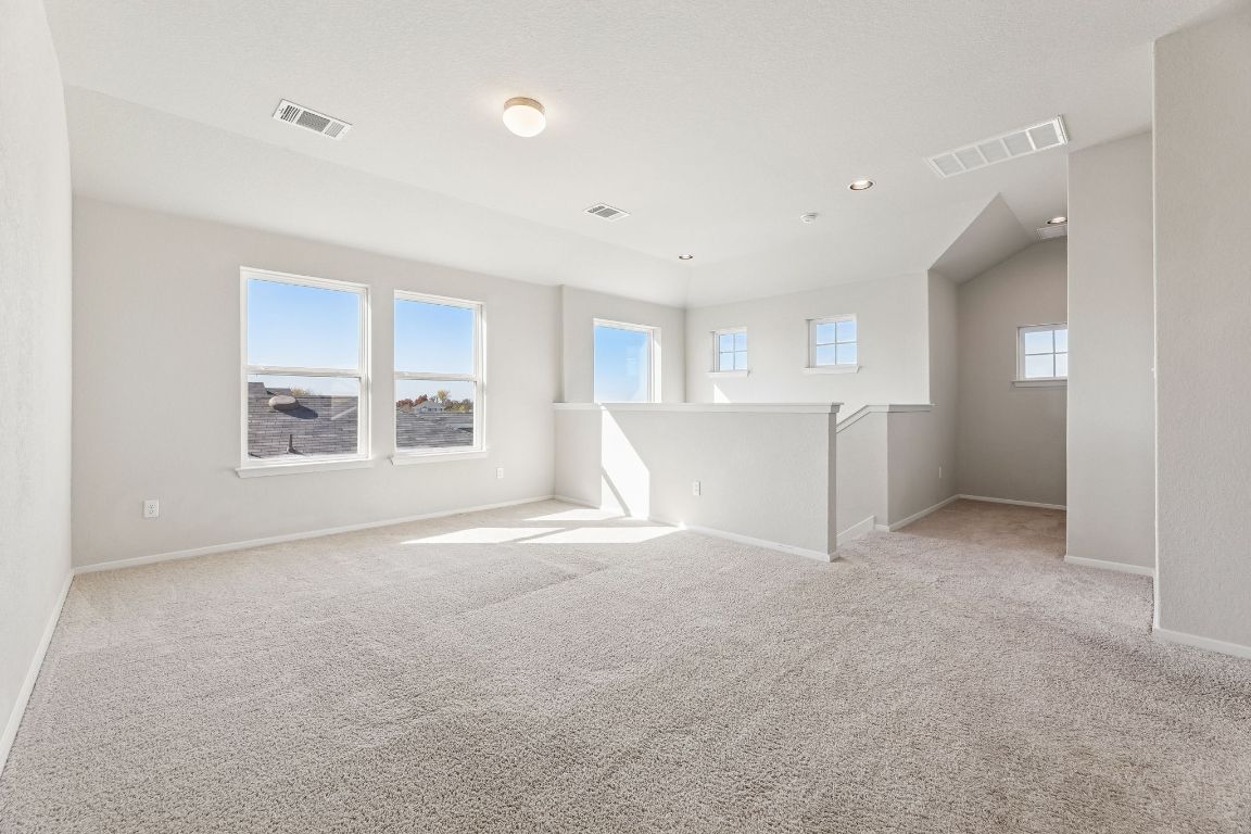 316 Insider Loop Elgin, TX 78621 - Photo 19 of 39 Unfurnished room with light colored carpet and recessed lighting