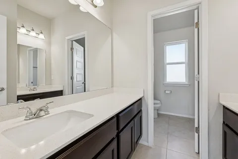 a view of a livingroom with kitchen and a window