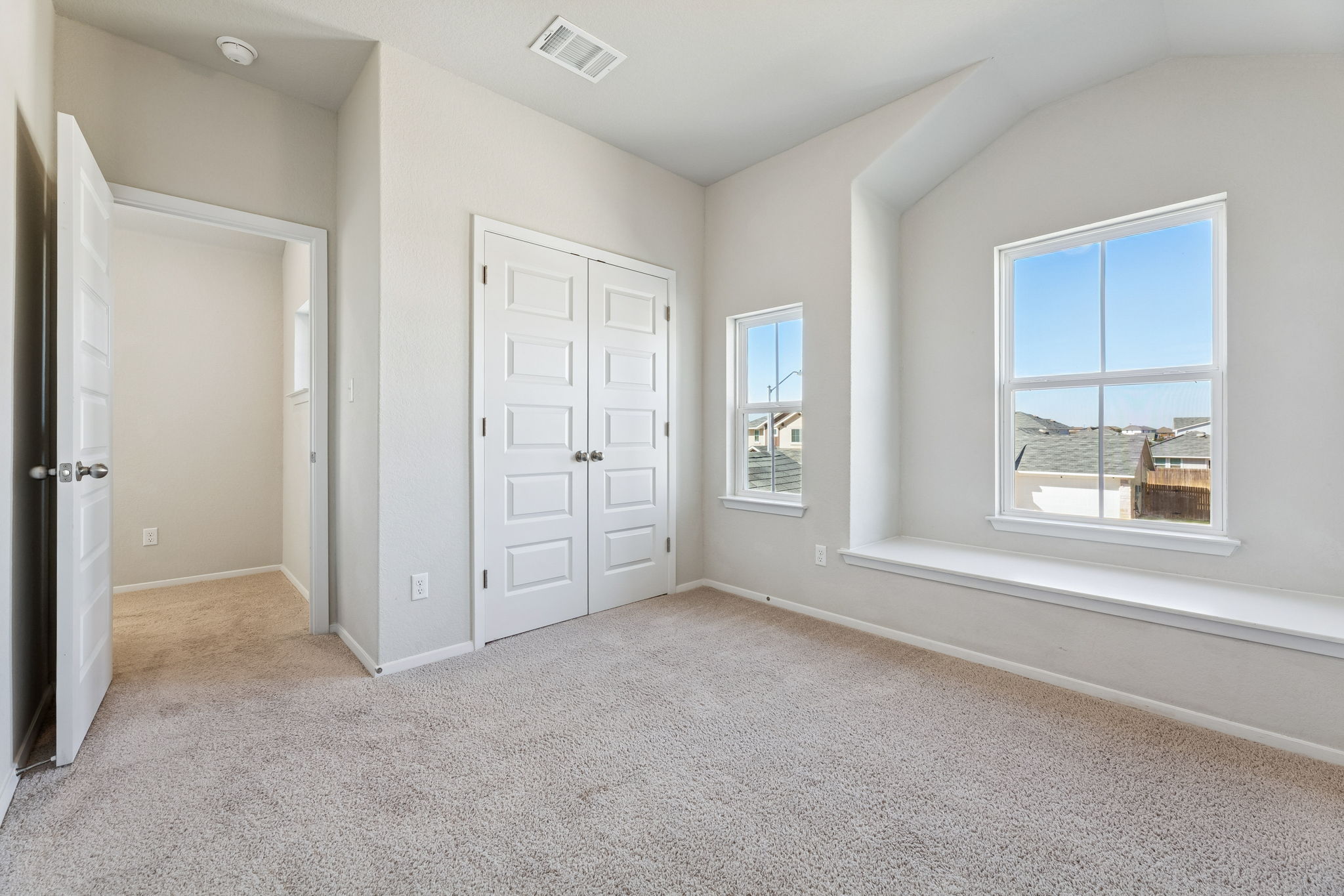 316 Insider Loop Elgin, TX 78621 - Photo 21 of 39 Unfurnished bedroom featuring light colored carpet, a closet, and vaulted ceiling