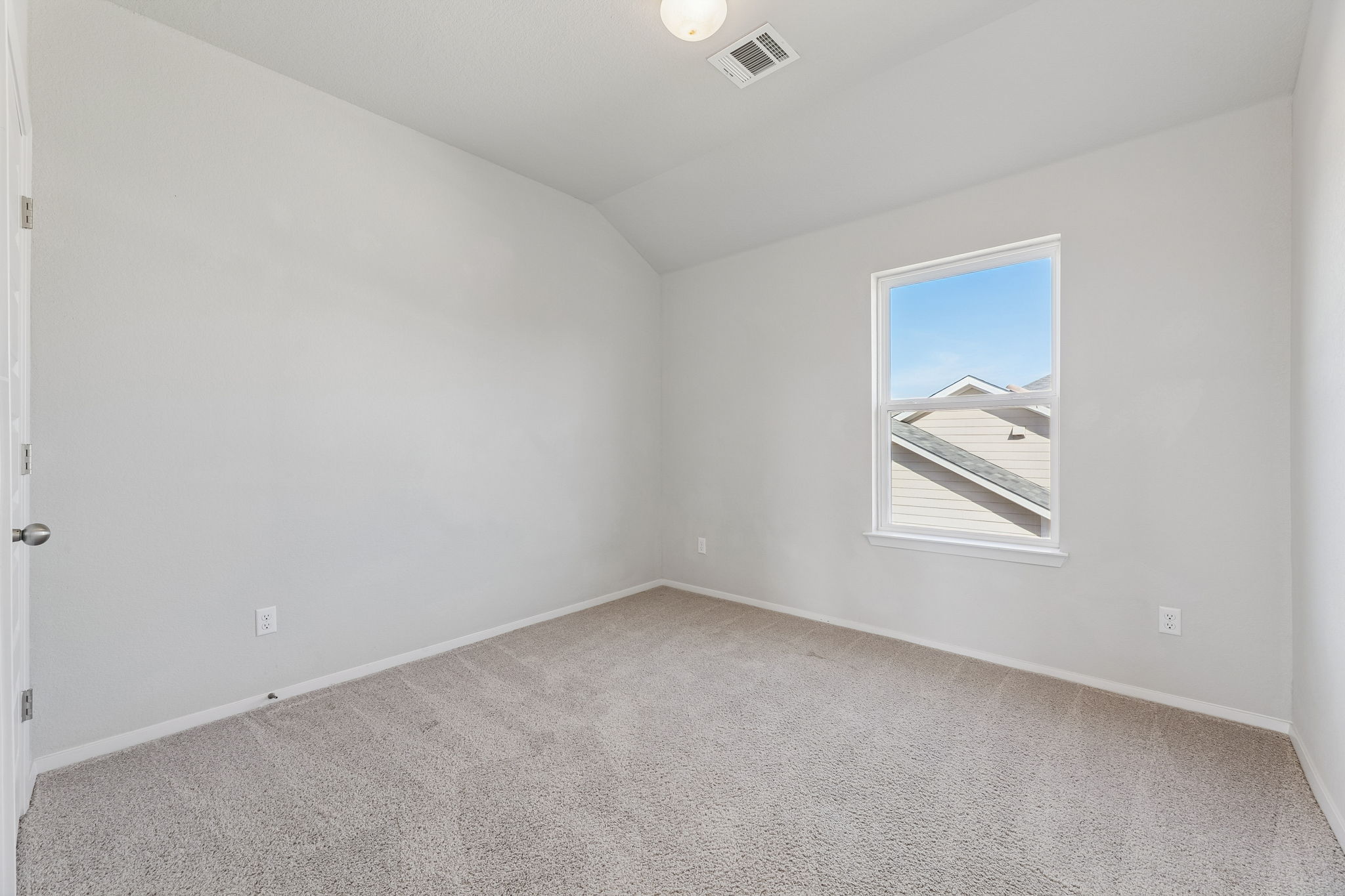 316 Insider Loop Elgin, TX 78621 - Photo 22 of 39 Spare room featuring vaulted ceiling and light colored carpet