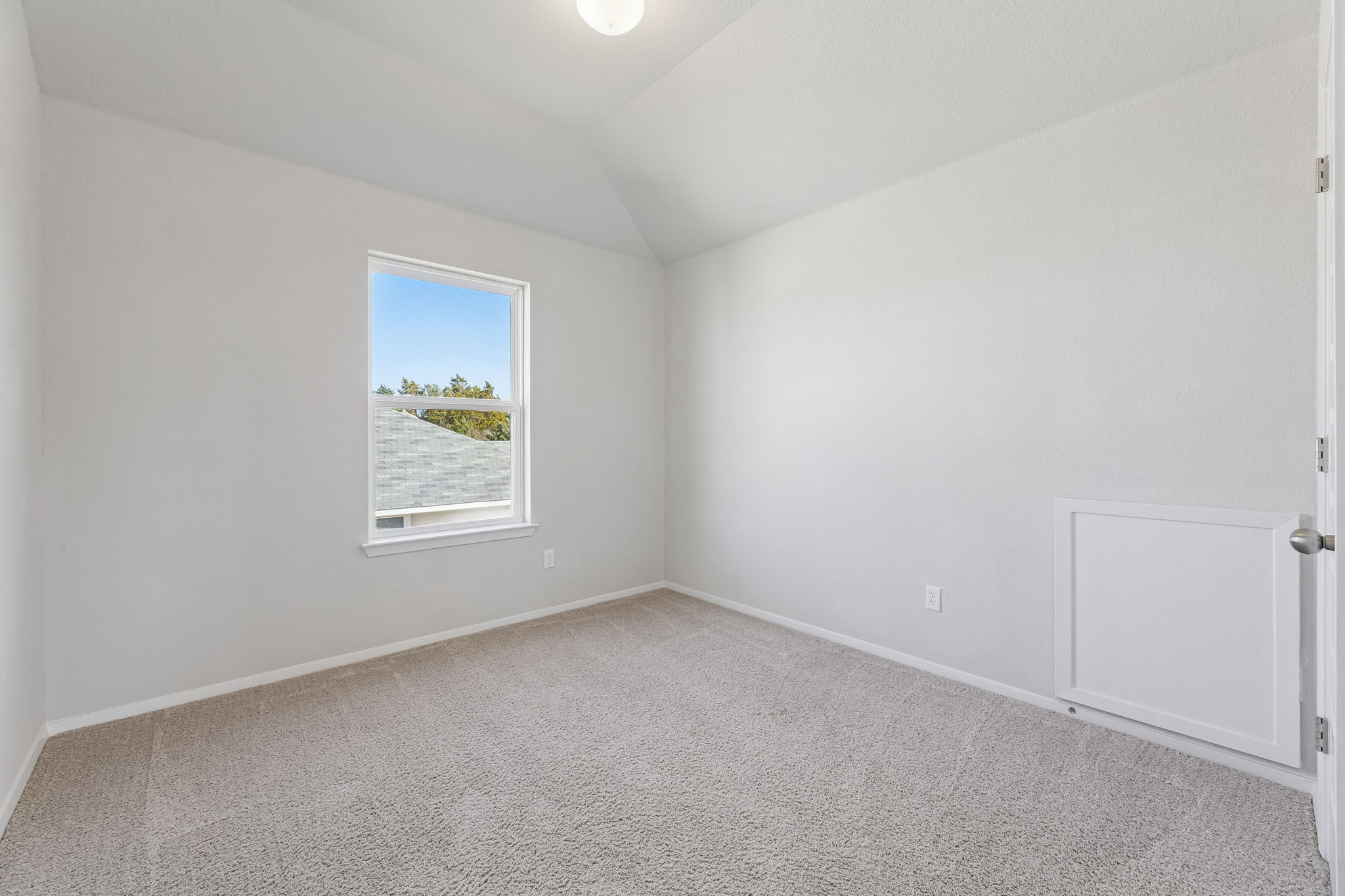 316 Insider Loop Elgin, TX 78621 - Photo 24 of 39 Carpeted empty room with vaulted ceiling and baseboards