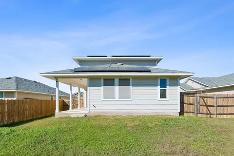 a house with swimming pool in front of it